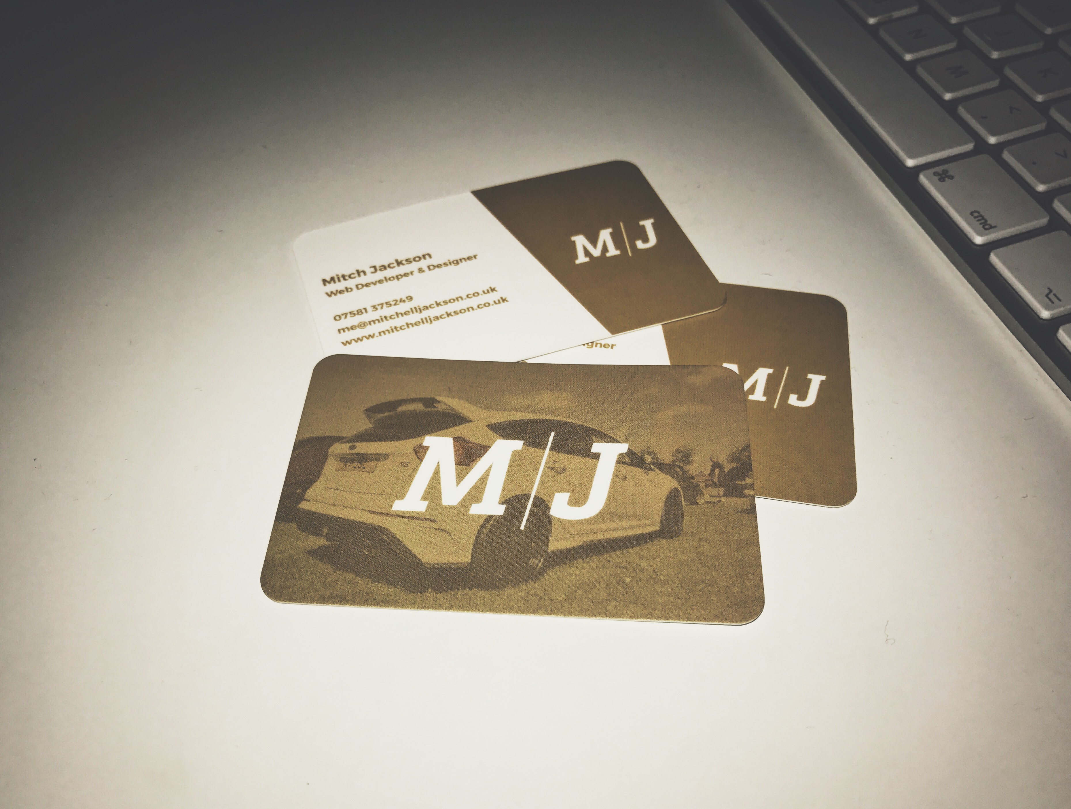 M/J business cards on white desk