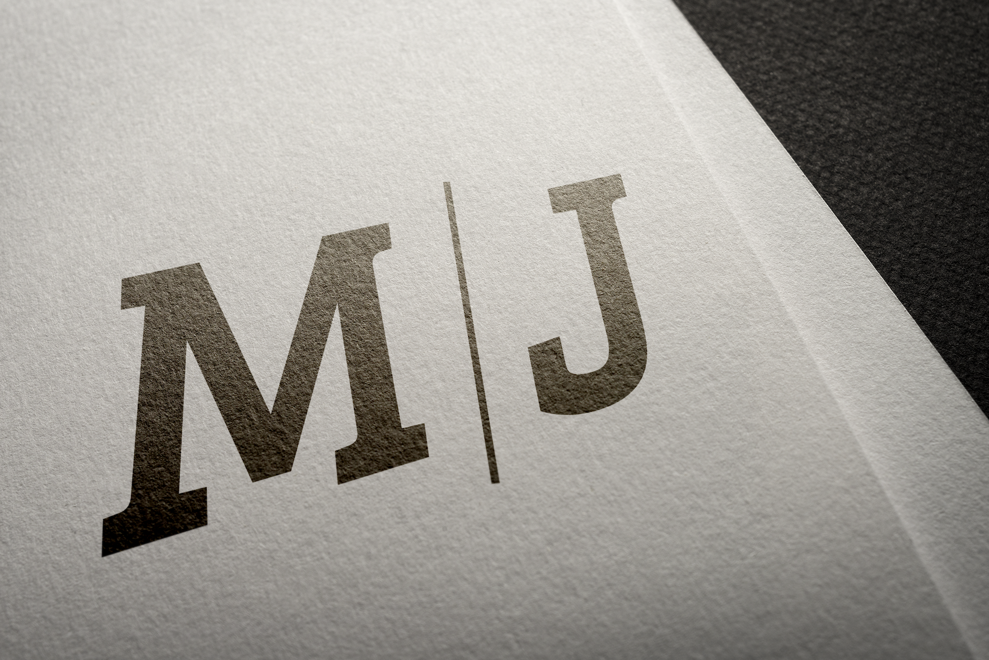 M/J black logo on white paper